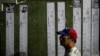 Presidential election tallies, or "actas," stream down a wall with the faces of prisoners detained amid a government crackdown, during a vigil in Caracas, Venezuela, Aug. 8, 2024.