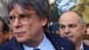 Carles Puigdemont, leader of Catalan separatist party Junts and its secretary general Jordi Turull, make their way as Puigdemont returns to Spain, during a welcoming event organised by his party in Barcelona, Spain, August 8, 2024. 
