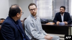 FILE - Swedish EU diplomat Johan Floderus, center, attends a court session in Tehran, Iran, Dec. 10, 2023. Floderus was arrested on Apr. 17, 2022, at Tehran airport as he was returning home from a trip with friends.