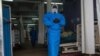 A member of the Ugandan Medical staff of the Ebola Treatment Unit stands inside the ward at Mubende Regional Referral Hospital in Uganda, Sept. 24, 2022. 