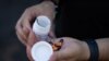 FILE - Kyle Planck, who has recovered from monkeypox, shows Tecovirimat capsules, which is used for monkeypox treatment, during an interview in New York, July 19, 2022. 
