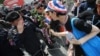 An anti-government protester gives a rose to Thai police officer during a rally in Bangkok, Nov. 25, 2013. 