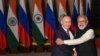 FILE - India's Prime Minister Narendra Modi, right, greets Russian President Vladimir Putin before a meeting at Hyderabad House in New Delhi, Dec. 6, 2021.