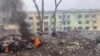 FILEL - A view shows cars and a building of a hospital destroyed by an aviation strike amid Russia's invasion of Ukraine, in Mariupol, Ukraine, in this handout picture released March 9, 2022 by the Press service of the National Police of Ukraine.