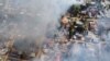 File - Smoke arises from burning buildings in Waraisuplia village in Kayah State, Myanmar where Myanmar’s military is targeting civilians in air and ground attacks, Feb. 18, 2022.