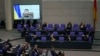 Members of the German parliament Bundestag listen to Ukraine President Volodymyr Zelenskyy during his virtual address to the parliament at the Reichstag Building, in Berlin, March 17, 2022.