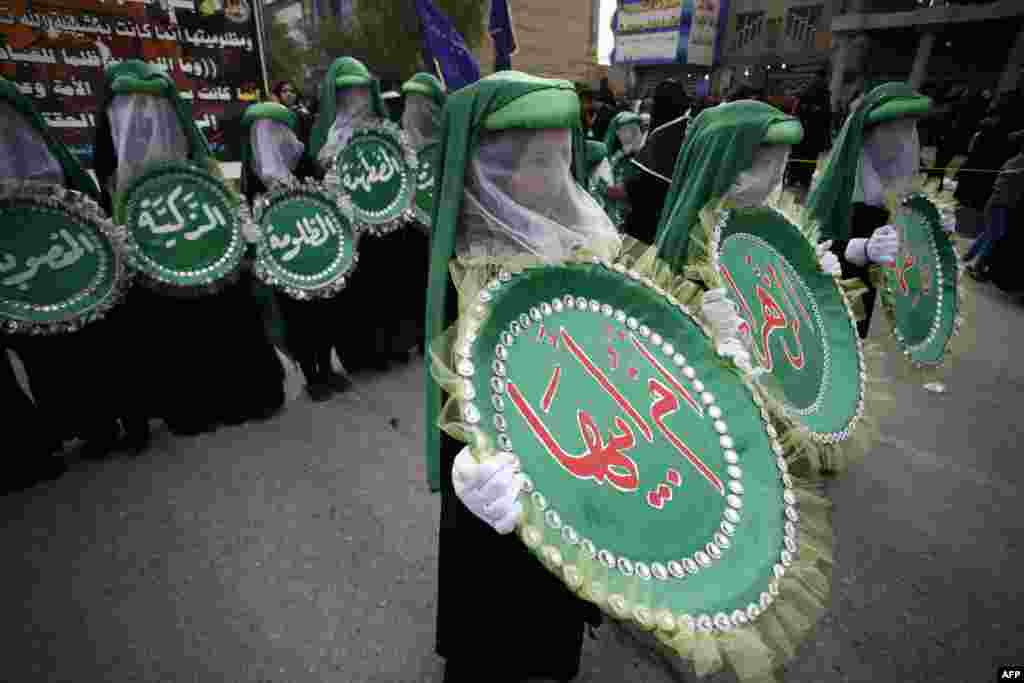 Supporters of senior Iraqi Shiite cleric Ayatollah Muhammad al-Yaqubi attend a religious ceremony to commemorate the death anniversary of Fatima, daughter of Prophet Mohammed, in the holy city of Najaf, Iraq.