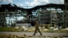 FILE - A Ukrainian serviceman walks past a gypsum manufacturing plant destroyed in a Russian bombing in Bakhmut in eastern Ukraine, May 28, 2022.