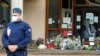 Flowers are stacked outside the school where slain history teacher Samuel Paty was working, in Conflans-Sainte-Honorine, northwest of Paris, France, Oct. 17, 2020.