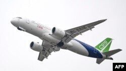 A Commercial Aircraft Corp of China (COMAC) C919 aircraft, China's first domestically produced large passenger jet, performs during the Airshow China 2022 in Zhuhai, in southern China's Guangdong province on November 8, 2022. (Photo by CNS /AFP)