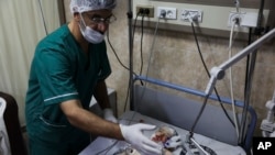 Doctors treat a child wounded after Syrian government forces shelled tent settlements housing families displaced by the country's conflict, Nov. 6, 2022.
