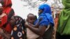 FILE - Internally displaced Ethiopians queue to receive food aid in the Higlo camp for people displaced by drought, in the town of Gode, Somali Region, Ethiopia, Apr. 26, 2022. 