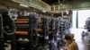 FILE - A worker checks machinery at a factory in Higashiosaka, Japan June 23, 2022. 