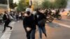 FILE - In this Sept. 19, 2022, photo taken by an individual not employed by the Associated Press and obtained by the AP outside Iran, women run away from anti-riot police during an anti-government protest in Tehran.
