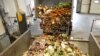 FILE - A truck offloads bio-waste of fruits and vegetables, in Stains, France, Nov. 19, 2021.