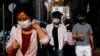 People wearing face masks walk through Wan Chai during the coronavirus disease (COVID-19) pandemic in Hong Kong, China, Apr. 14, 2022. 