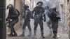Palestinians shoot fireworks at Israeli police in the Old City of Jerusalem, April 17, 2022. 