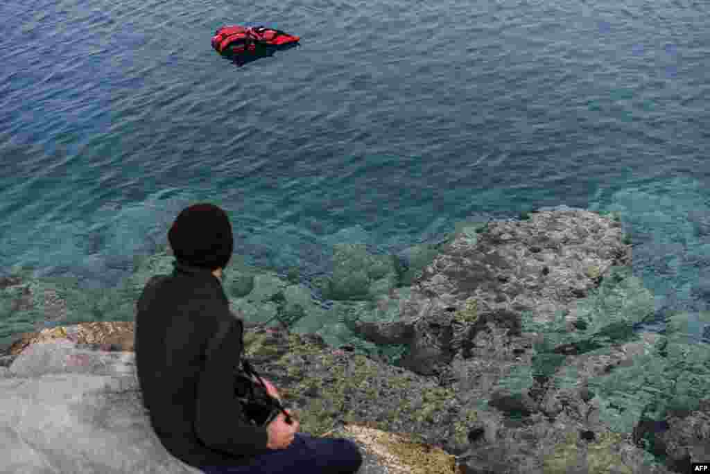 A life jacket floats on the sea near the port of Dikili district in Izmir, Turkey, where a ferry carrying a second group of migrants deported from Greece was scheduled to arrive Friday.