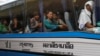 FILE PHOTO - Cambodian migrant workers sit in a bus upon arrival at Cambodia-Thailand's international border gate in Poipet, Cambodia, from Thailand, Tuesday, June 17, 2014.