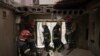 Firefighters work to secure a residential building previously damaged by a Russian strike in Kharkiv, Ukraine, April 9, 2022.