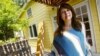 File — Homeowner Ingrid Auyon, an attorney, outside her Los Angeles-area home. On average, single women own more homes than unwed men in the nation's 50 largest metropolitan areas, according to an analysis of U.S. Census Bureau data.