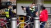 Victoria Police Protective Services Officers speak to a man on the first day of a five-day lockdown implemented in the state of Victoria in response to a coronavirus disease (COVID-19) outbreak in Melbourne, Australia, Feb. 13, 2021. 