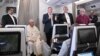 Archbishop of Canterbury Justin Welby (2ndR), Pope Francis (2ndL) and Church of Scotland's Iain Greenshields (3rdR) address the media while aboard the plane from Juba to Rome on Feb. 5, 2023.