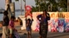 Street children play with red ribbon left on display by activists on the banks of the Hooghly River ahead of World AIDS Day in Kolkata, India, Nov. 30, 2022.