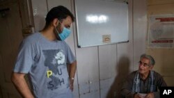 FILE - Activist Khurram Parvez, left, speaks with human rights lawyer Parvez Imroz in Srinagar, Indian-controlled Kashmir, Aug. 25, 2020. He was named a winner of the Martin Ennals Award for human rights campaigners on Jan. 19, 2023.