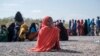 FILE - A girl sits as she waits in line with dozens of other internally displaced people to be registered by local authorities at a compound in Semera, Afar region, Ethiopia, Feb. 14, 2022. 