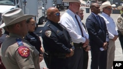 FILE - Uvalde School Police Chief Pete Arredondo, third from left, stands during a news conference outside of the Robb Elementary school in Uvalde, Texas, on May 26, 2022.