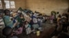 FILE - Internally displaced children, fleeing clashes between M23 rebels and Congolese soldiers, eat a meal prepared by volunteers in Kanyarushinya, north of Goma, May 27, 2022.