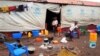 FILE - Children walk out of a tent at a refugee camp in Dundo, Angola, Sept. 12, 2017. Under a renewed repatriation initiative, dozens of Congolese left Angola for their home country Tuesday.