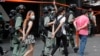 FILE - Police detain protesters after a rally in Causeway Bay before the annual handover march in Hong Kong, July 1, 2020, which marks the date in 1997 when Britain transferred sovereignty over its former colony to China.