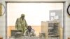 FILE - A journalist talks with his studio technician during a radio broadcast at ORTM's (Office of Radio and Television in Mali) Timbuktu office, in Timbuktu, Mali, Dec. 7, 2021.