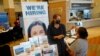 FILE - Marriott human resources recruiter Mariela Cuevas, left, talks to Lisbet Oliveros, during a job fair in Florida, Sept. 3, 2021.