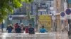 People wade through floodwaters in Chiang Mai Province, Thailand, Oct. 6, 2024 as the city's main river overflowed its banks following heavy seasonal rainfall. 