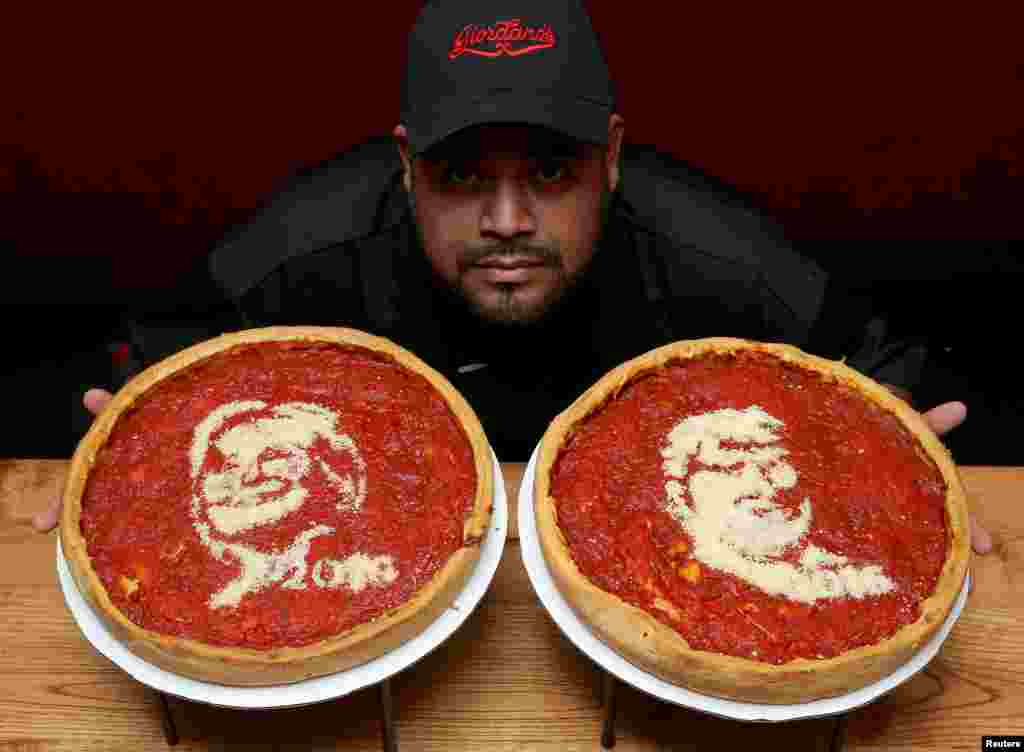 Kepala juru masak, Fabian Martinez, berpose dengan sebuah pizza yang dihiasi gambar kandidat presiden dari Partai Demokrat, Hillary Clinton (kiri) dan kandidat presden Partai Republik, Donald Trump, di Pizzeria Giordano.&nbsp; Chicago, Illinois, 27 September 2016.
