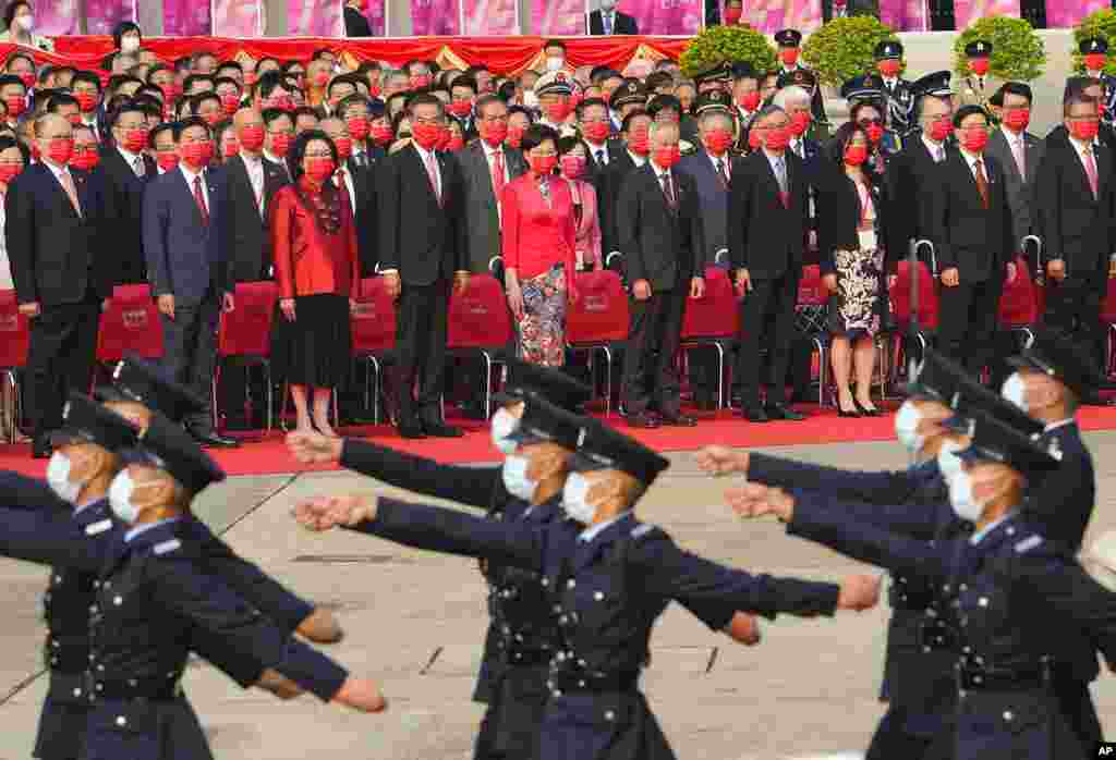 Hong Kong Chief Executive Carrie Lam, center, and other officials attend the flag raising ceremony for the celebration of China&#39;s National Day at the Golden Bauhinia Square, in Hong Kong.
