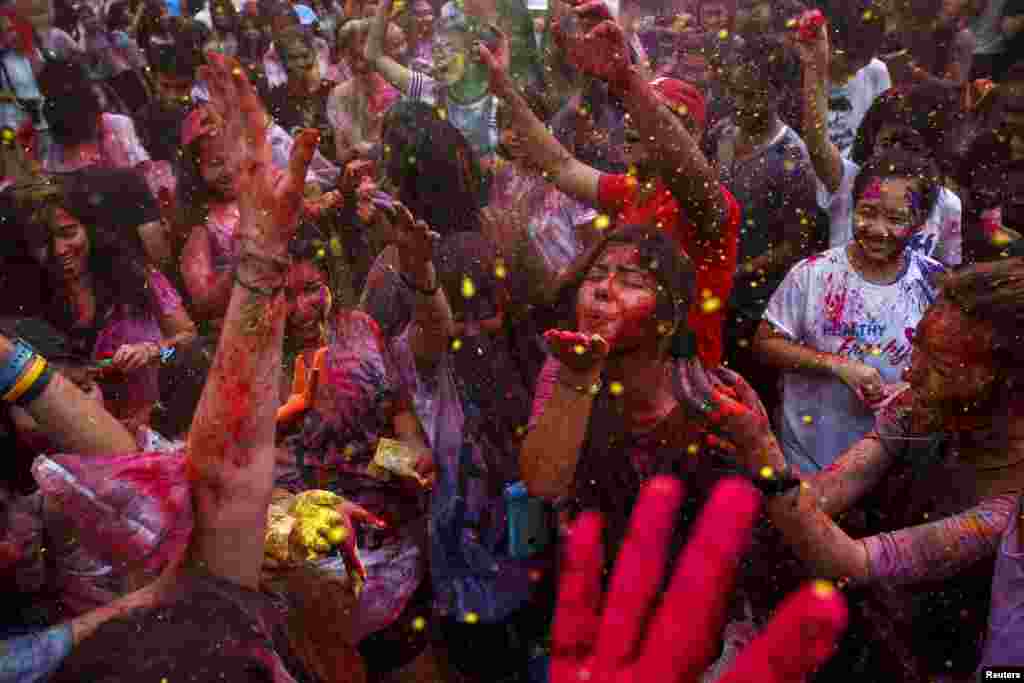 Revelers take part in the annual Holi Rangotsav Festival organized by Vishwa Hindu Parishad Association at a university in Bangkok, Thailand.