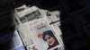 A newspaper with a cover picture of Mahsa Amini, a woman who died after being arrested by the Islamic republic's 'morality police' is seen in Tehran, Sept. 18, 2022. (Majid Asgaripour/West Asia News Agency)