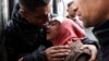 A Palestinian injured in an Israeli strike mourns the death of her sibling in the strike, at Abu Yousef Al-Najjar hospital in Rafah in the southern Gaza Strip on Feb. 23, 2024.