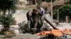 FILE - Members of the Islamist rebel group al-Nusra Front prepare a homemade mortar in the Bustan al-Qasr neighborhood of Aleppo, Syria, June 5, 2014. 