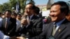 FILE PHOTO - Opposition leader of Cambodia National Rescue Party Sam Rainsy, center, delivers a speech next to his Deputy President Kem Sokha, right, during a gathering to mark Human Rights Day, in front of National Assembly, in Phnom Penh, Cambodia.