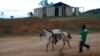 FILE - In this May 23, 2013 photo, a resident of Belle Anse returns home from the market in Haiti. A drought the year before destroyed key crops, followed by flooding from Tropical Storm Isaac and Hurricane Sandy.