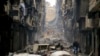 FILE - Residents walk through the destruction of the once rebel-held Salaheddine neighborhood in the eastern Aleppo, Syria, Jan. 20, 2017. 