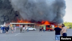 Smoke rises from a shopping mall hit by a Russian missile, in Kremenchuk, Ukraine, June 27, 2022. (Telegram/V_Zelenskiy_official/Handout via Reuters)