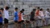 FILE - Youths attend a daily track-and-field class, part of a training course at the Jinshan Youth Spare-time Sports School, in Shanghai, Aug. 25, 2015. About 30 youths are enrolled and top performers will be groomed to become professional athletes.