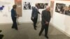 Former President Jimmy Carter and former first lady Rosalynn Carter tour the "Countdown to Zero" with Donald Hopkins, former director of Carter Center Health Programs, during a press event at the Jimmy Carter Library and Museum in Atlanta, Georgia, Jan. 11, 2017. (K. Farabaugh/VOA)