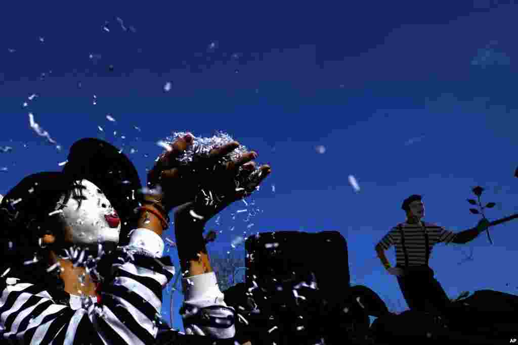 A child blowing confetti from her hands during a Carnival parade in Cyprus&#39; coastal city of Limassol. Limassol&#39;s long-established parade is Cyprus&#39; biggest and most famous, drawing revelers from across the east Mediterranean island.